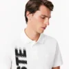 Herrpikétröja i normal passform med Lacoste Movement-tryck Herrpikétröja i normal passform med Lacoste Movement-tryck